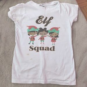 The color is white and the shirt says elf squad